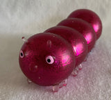 Hot pink squidgy disco caterpillar. Sensory fidget toys
