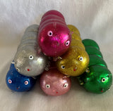 Squidgy disco caterpillar. Shiny colours include blue, silver, green, gold, light pink and hot pink. Sensory fidget toys
